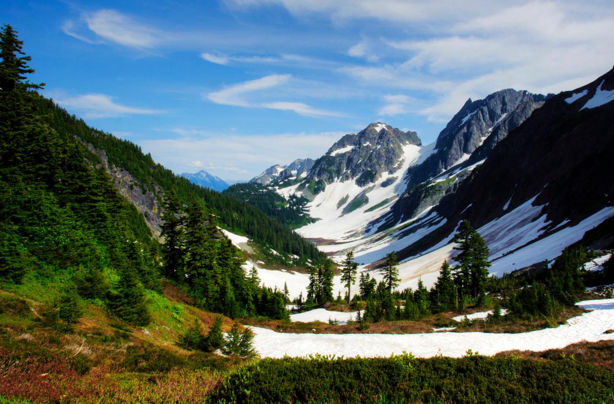 The sun shines on Cascade Pass and Pelton Basin at North Cascades National Park. Park ranger Brendan Oates said even in the summer, visitors can still walk in the snow at higher elevations.