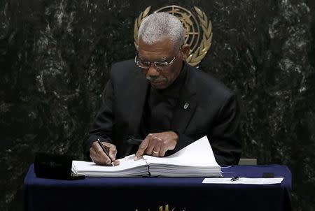 Guyana President David Granger signs the Paris Agreement on climate change at the United Nations Headquarters in Manhattan, New York, U.S., April 22, 2016. REUTERS/Mike Segar