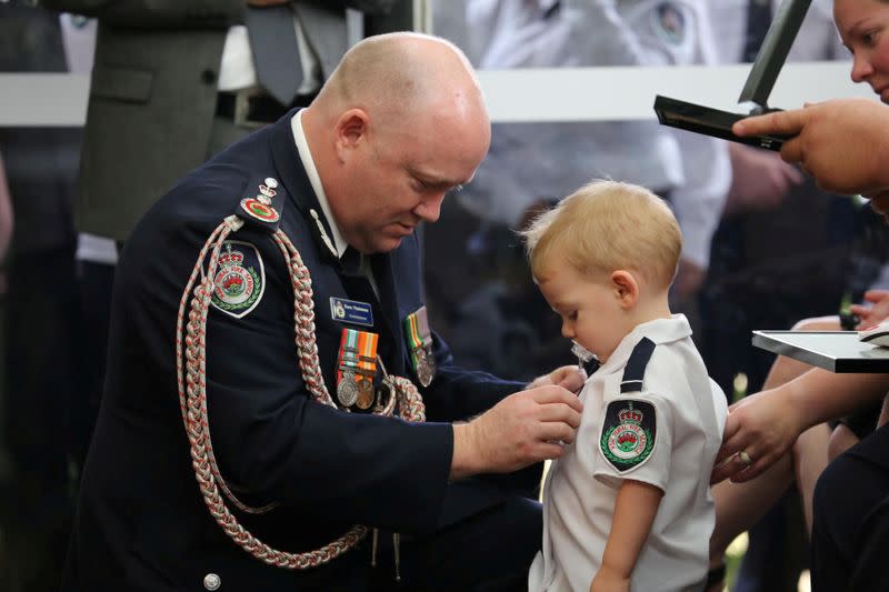 RFS Commissioner Shane Fitzsimmons presents a posthumous Commendation for Bravery and Service to the son of late RFS volunteer Keaton in Buxton