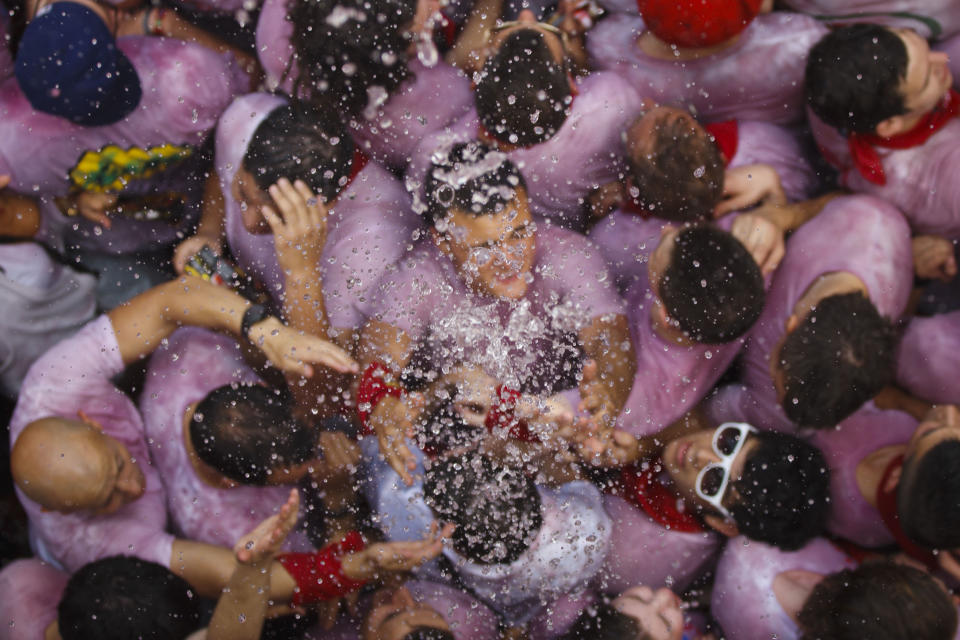 Revelers are sprayed with water after the 'Chupinazo', the official opening of the 2012 San Fermin fiestas, Friday, July 6, 2012 in Pamplona, Spain. Can we expect on Syrian Brig. Gen. Manaf Tlass had abandoned Assad's regime. (AP Photo/Daniel Ochoa de Olza)