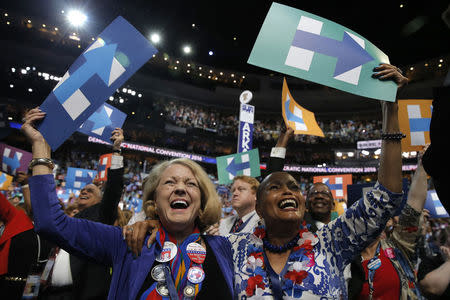 Delegates celebrate after Democratic presidential candidate Hillary Clinton won the Democratic presidential nomination at the Democratic National Convention in Philadelphia, Pennsylvania, U.S., July 26, 2016. REUTERS/Jim Young
