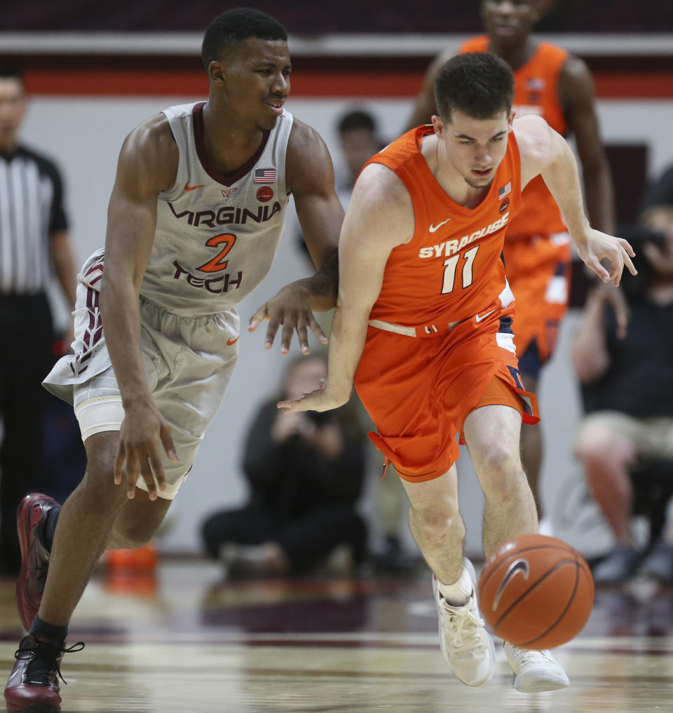 Syracuse's Joseph Girard III (11) steals a pass intended for of Virginia Tech's Landers Nolley II (2) during the first half of an NCAA college basketball game in Blacksburg Va., Saturday, Jan. 18 2020. (Matt Gentry/The Roanoke Times via AP)