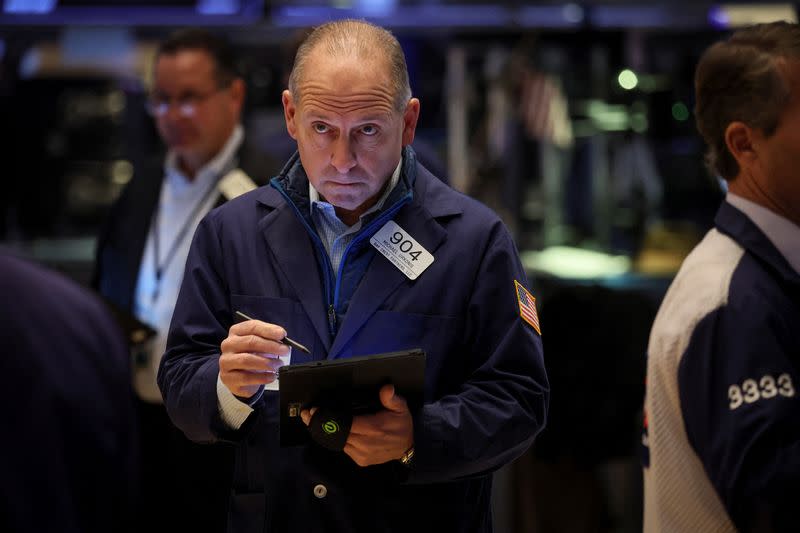 Traders work on the floor of the NYSE in New York