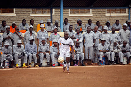 Kenyan prisoners watch a mock World Cup soccer match between Russia and Saudi Arabia, as part of a month-long soccer tournament involving eight prison teams at the Kamiti Maximum Prison, Kenya's largest prison facility, near Nairobi, Kenya, June 14, 2018. REUTERS/Baz Ratner