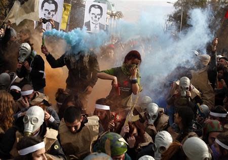 Protesting students wearing fake military uniforms and gas masks participate in a demonstration in front of the parliament in Sofia November 20, 2013. REUTERS/Stoyan Nenov