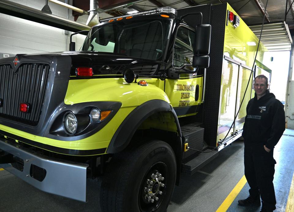 Bronson Fire Chief Scott Wilber stands next to the new massive "Tanker 10" put in full service last week by the department.