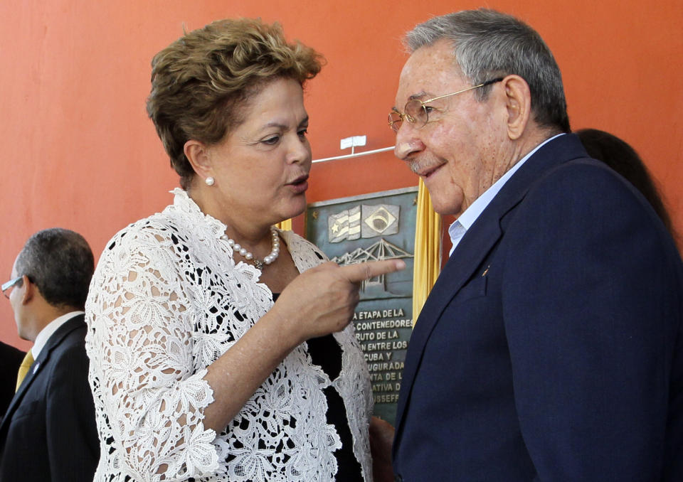 Brazil's President Dilma Rousseff, left, and Cuba's President Raul Castro talk during the inauguration ceremony of the first phase of a port overhaul project in Mariel, Cuba, Monday, Jan. 27, 2014. The new port will be able to accommodate deeper-drafting "post-Panamax" ships that will begin crossing the Panama Canal once an expansion project there is completed in the next year or so.(AP Photo/Ismael Francisco, Cubadebate)