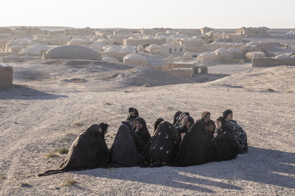 Afghan women mourn for relatives killed in an earthquake at a burial site after an earthquake in Zenda Jan district in Herat province, western of Afghanistan, Sunday, Oct. 8, 2023. Powerful earthquakes killed at least 2,000 people in western Afghanistan, a Taliban government spokesman said Sunday. It's one of the deadliest earthquakes to strike the country in two decades. (AP Photo/Ebrahim Noroozi)