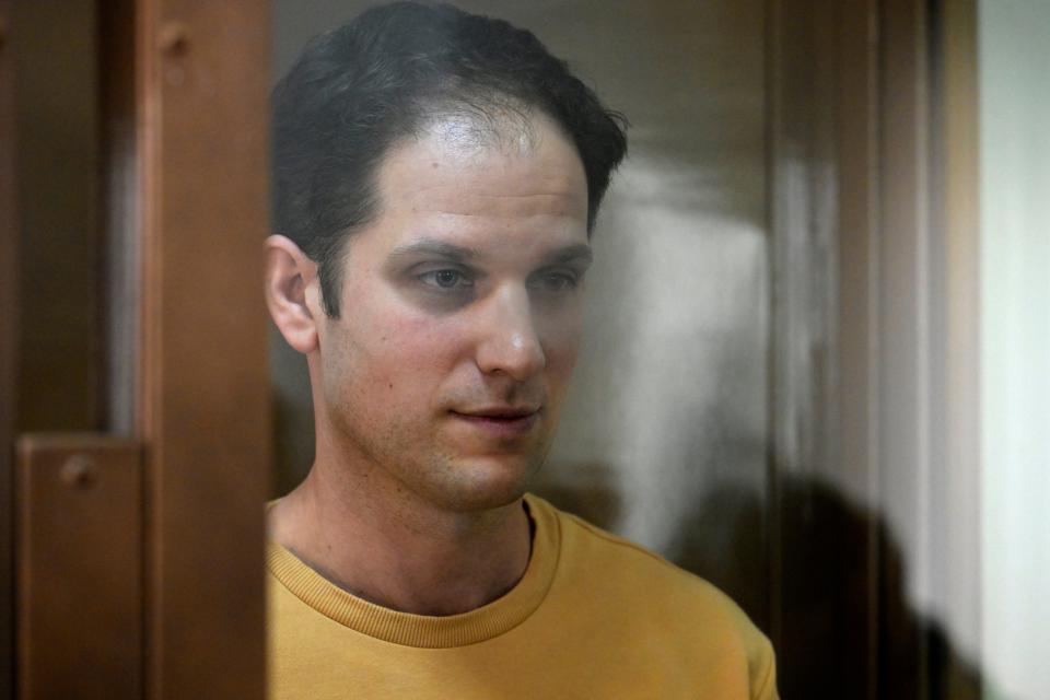 Wall Street Journal reporter Evan Gershkovich stands in a glass cage in a courtroom at the Moscow City Court, in Moscow, Russia, 19 September 2023 (AP)