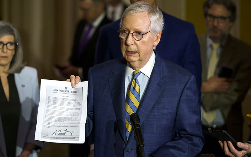 Minority Leader Mitch McConnell (R-Ky.) holds up a letter from U.S. Capitol Police Chief Thomas Manger discussing the release of Jan. 6 footage