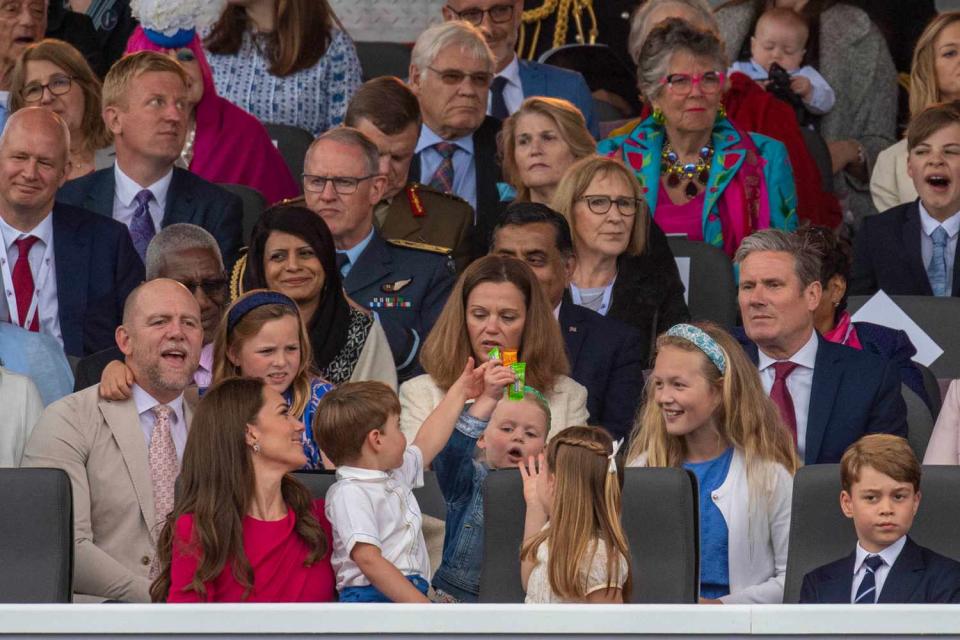 Back: Mike Tindall, Mia Tindall, Lena Tindall and Savannah Phillips; Front: (L-R) Prince Louis of Cambridge, Catherine, Duchess of Cambridge, Princess Charlotte of Cambridge, Prince George of Cambridge and Prince William, Duke of Cambridge watch the Platinum Pageant on June 05, 2022 in London, England. The Platinum Jubilee of Elizabeth II is being celebrated from June 2 to June 5, 2022, in the UK and Commonwealth to mark the 70th anniversary of the accession of Queen Elizabeth II on 6 February 1952.