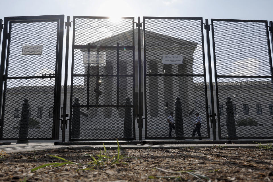 FILE: The U.S. Supreme Court Building is seen through a temporary security fence on June 23, 2022 in Washington, DC.  / Credit: Photo by Anna Moneymaker/Getty Images