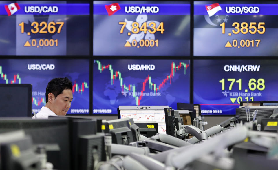 A currency trader watches monitors at the foreign exchange dealing room of the KEB Hana Bank headquarters in Seoul, South Korea, Monday, Aug. 19, 2019. Asian shares were higher Monday, as investors continue to rejigger their read on President Donald Trump's trade war and growing worries about slowing economies around the world.(AP Photo/Ahn Young-joon)