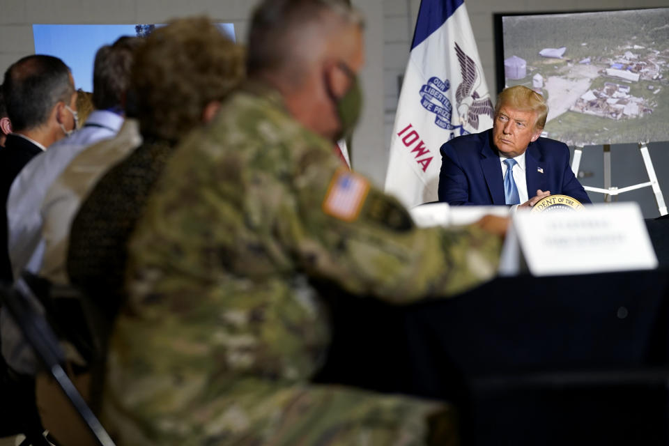 CORRECTS FROM FLOOD DAMAGE TO DERECHO DAMAGE - President Donald Trump listens during a briefing on derecho damage and recovery efforts in Iowa, Tuesday, Aug. 18, 2020, in Cedar Rapids, Iowa. (AP Photo/Evan Vucci)