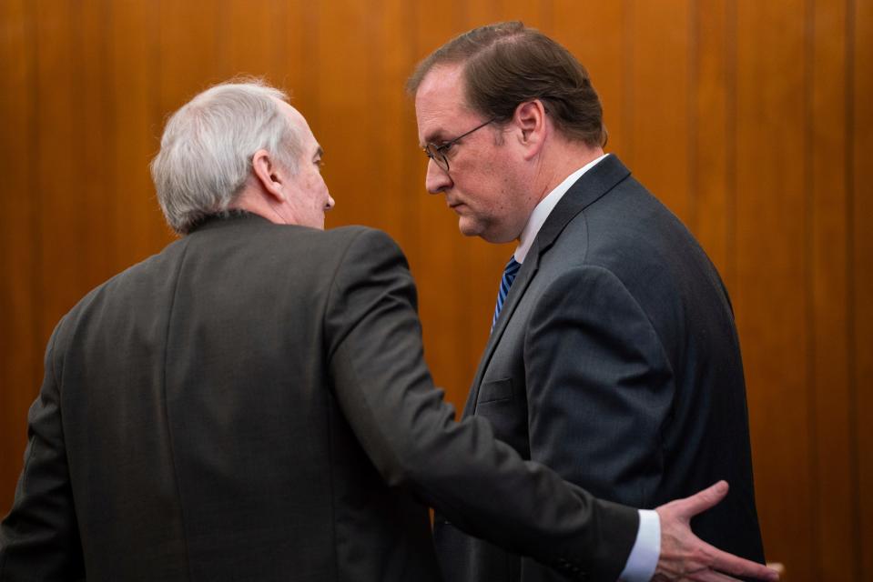 Attorney James Joseph Sullivan, left, speaks with his client David Sutherland, an attorney who has been charged with embezzling hundreds of thousands of dollars from recently deceased Carhartt heiress Gretchen Valade's trust, after an arraignment hearing at Grosse Pointe Farms Municipal Court on Jan. 11, 2023.