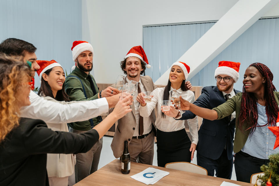 colleagues toasting champagne glasses at a holiday party