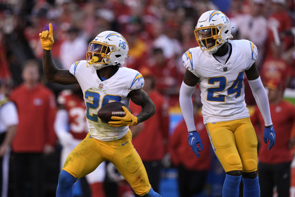 Los Angeles Chargers cornerback Asante Samuel Jr. (26) celebrates after intercepting a pass as teammate AJ Finley (24) watches during the first half of an NFL football game against the Kansas City Chiefs Sunday, Oct. 22, 2023, in Kansas City, Mo. (AP Photo/Charlie Riedel)