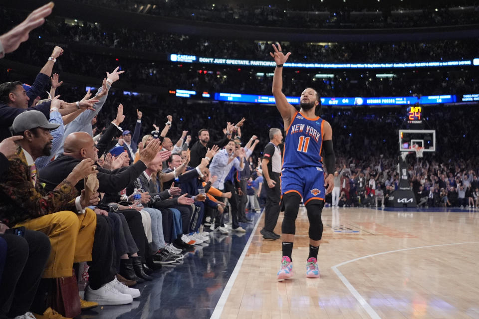 Jalen Brunson (11) of the New York Knicks gestures to fans after making a three-point shot during the second half of Game 5 in an NBA basketball second-round playoff series against the Indiana Pacers, Tuesday , May 14, 2024, in New York.  The Knicks won 121-91.  (AP Photo/Frank Franklin II)