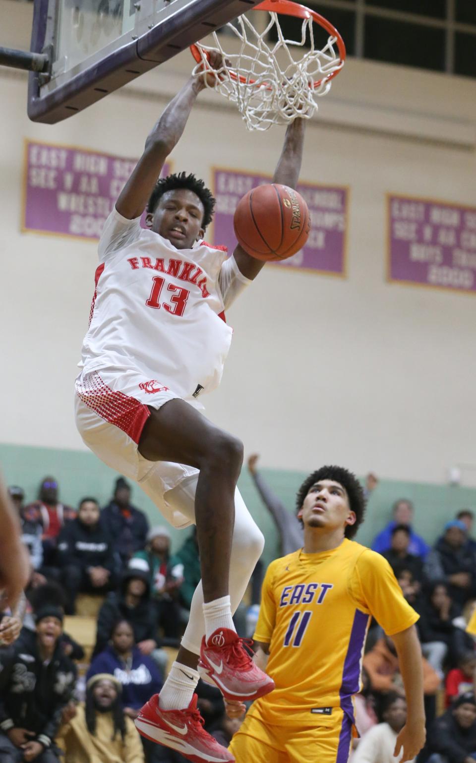 Franklin's Terence Thompson slams in two as East's Markell Johnson looks on in the second quarter.