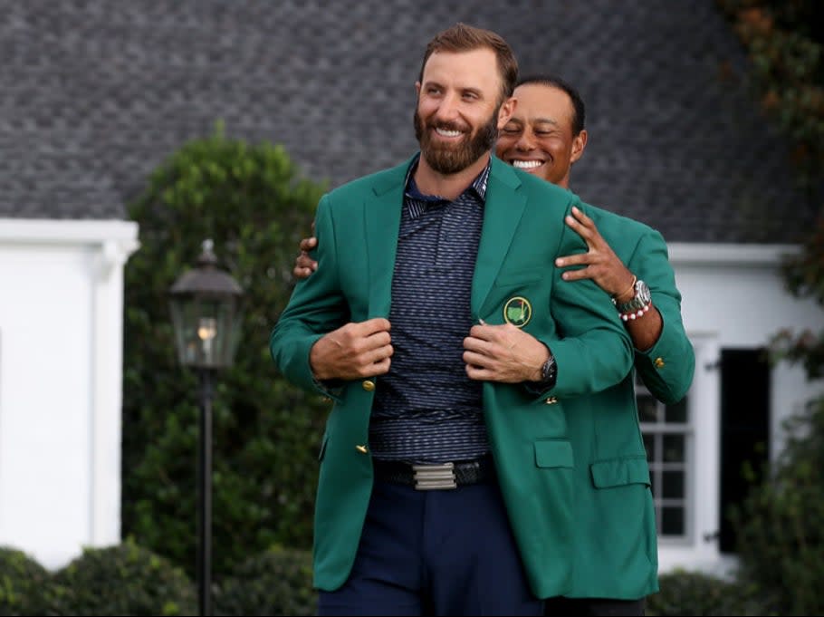 Dustin Johnson receives the Green Jacket from Tiger WoodsGetty Images