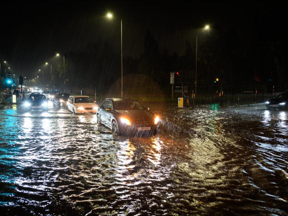 Vehicles negotiate a flooded section of the A1 road in London on Wednesday night (Leon Neal/Getty Images)