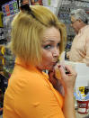 Kathy Babcock kisses her Mega Millions lottery tickets at the Farragut Market Thursday, March 29, 2012 in Knoxville, Tenn. With a half-billion-dollar multi-state lottery jackpot up for grabs, plenty of folks are fantasizing about how to spend the money. (AP Photo/Knoxville News Sentinel, Michael Patrick)