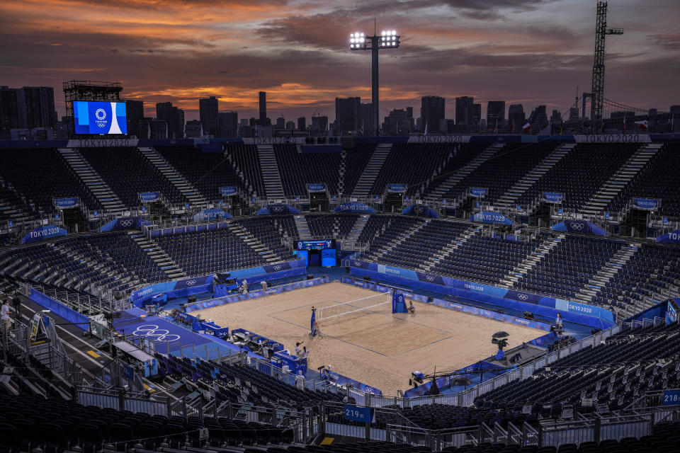 The sun sets during a break of beach volleyball at the 2020 Summer Olympics in Shiokaze Park, Tokyo, Japan on Monday, July 26, 2021.(AP Photo/Petros Giannakouris),