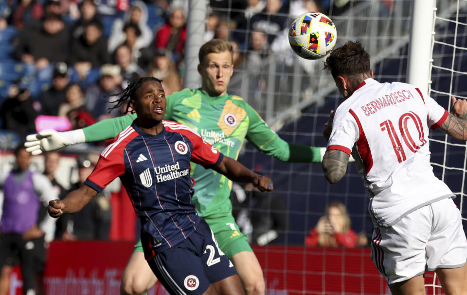Toronto FC forward Federico Bernardeschi (10) attempts to score against New England Revolution defender Nick Lima, left, and goalkeeper Henrich Ravas, center, in the first half of an MLS soccer match Sunday, March 3, 2024, in Foxborough, Mass. (AP Photo/Mark Stockwell)
