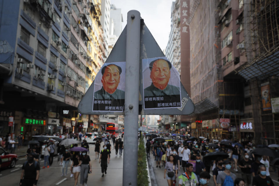 Posters of former Chinese leader Mao Zedong are seen on road sign during a protest in Hong Kong, Saturday, Oct. 12, 2019. The protests that started in June over a now-shelved extradition bill have since snowballed into an anti-China campaign amid anger over what many view as Beijing's interference in Hong Kong's autonomy that was granted when the former British colony returned to Chinese rule in 1997. (AP Photo/Kin Cheung)