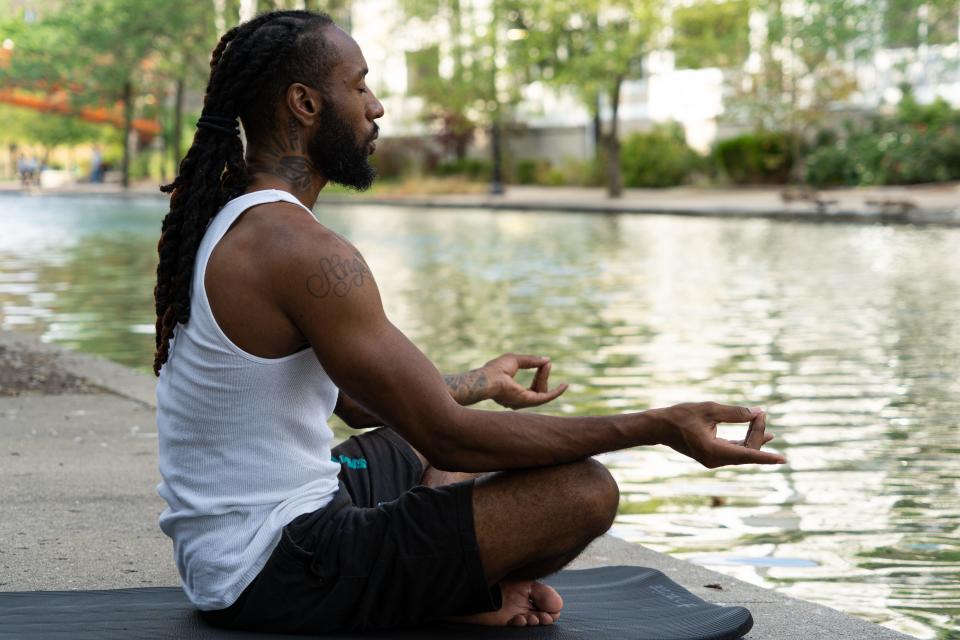 De'shon McClain poses for a portrait on Thursday, July 7. McClain received his yoga teacher training certification this year, hoping to bring the 'healing powers' of yoga into communities of color.