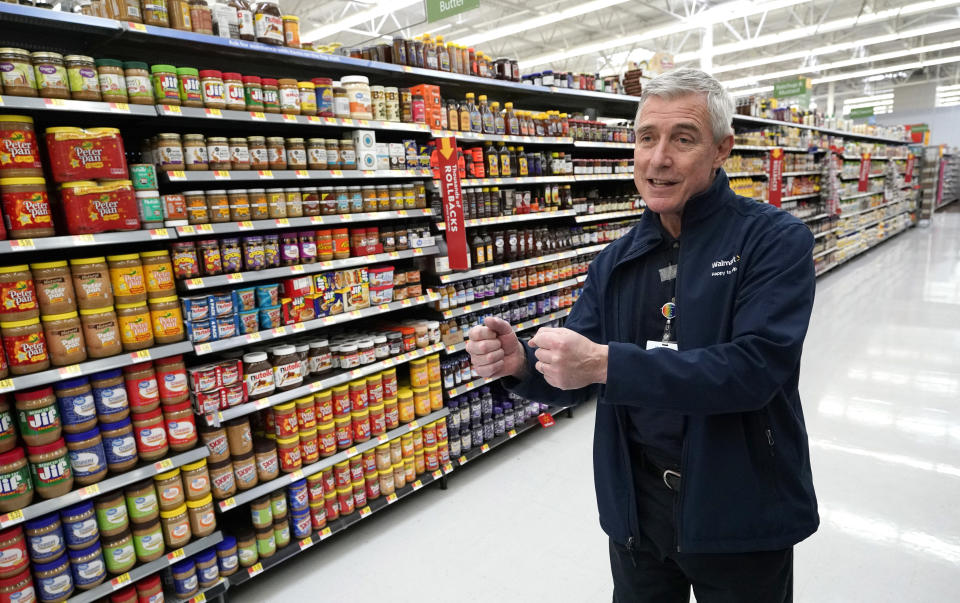 Walmart U.S. President and CEO Greg Foran talks about using a robot to scan shelves and help employees with restocking at a Walmart Supercenter Friday, Nov. 9, 2018, in Houston. (AP Photo/David J. Phillip)