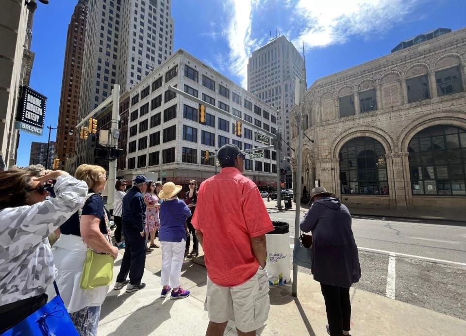 Attendees of a Detroit Historical Society tour are shown on the move in Detroit.