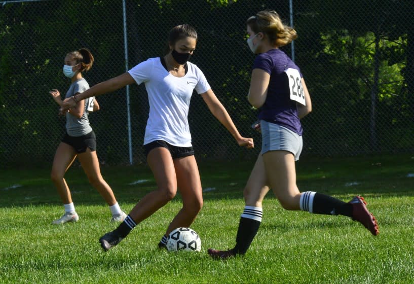 Members of the Brattleboro, Vt., Union High School's girls' varsity soccer team practice the season in 2020.