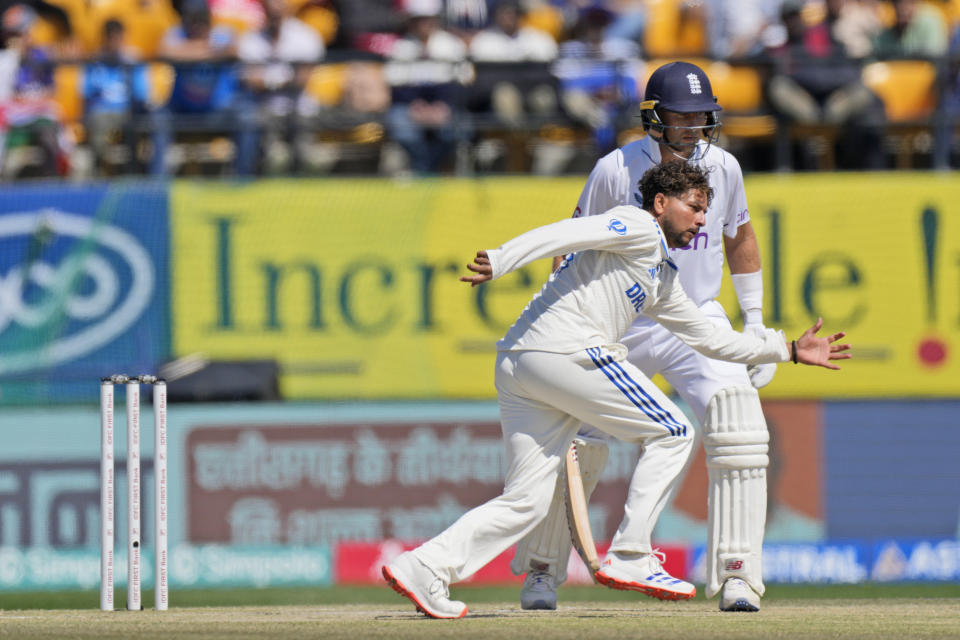 India's Kuldeep Yadav stretches to field a shot on his own bowling on the third day of the fifth and final test match between England and India in Dharamshala, India, Saturday, March 9, 2024. (AP Photo /Ashwini Bhatia)