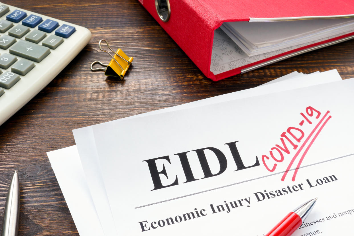 Economic Injury Disaster Loan EIDL and handwritten word covid-19.