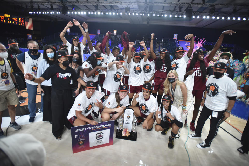 In this photo provided by Bahamas Visual Services, the South Carolina women's team poses with the trophy defeating UConn 73-57 to win the championship game at the Battle 4 Atlantis NCAA college basketball game at Paradise Island, Bahamas, Monday, Nov. 22, 2021. Standing at front left is head coach Dawn Staley. (Donald Knowles/Bahamas Visual Services via AP)