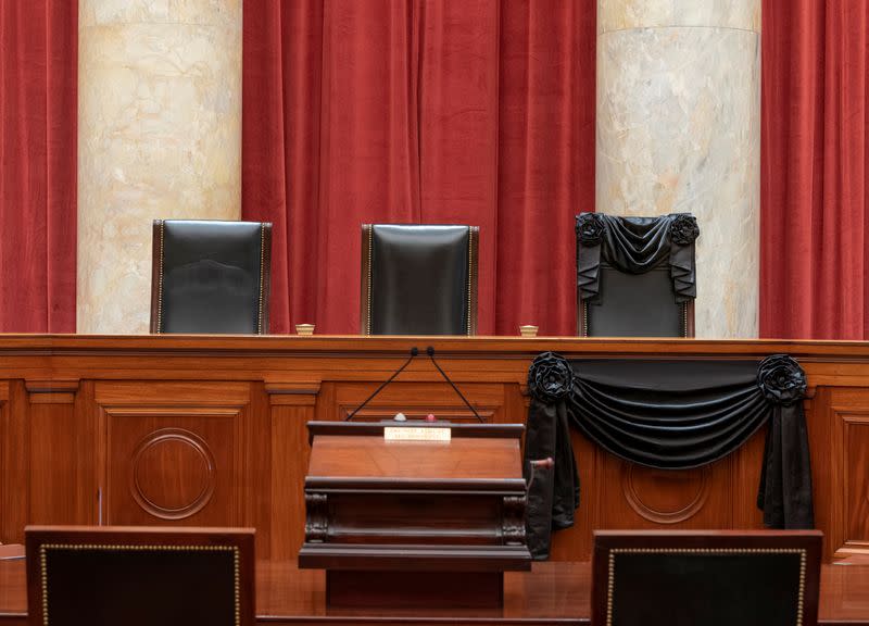 An interior view of the Supreme Court shows the bench draped with black bunting in honor of the late Justice Ruth Bader Ginsburg in Washington