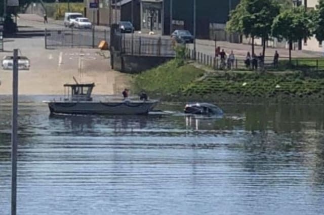 Woman rescued by ferry skipper after driving car into river