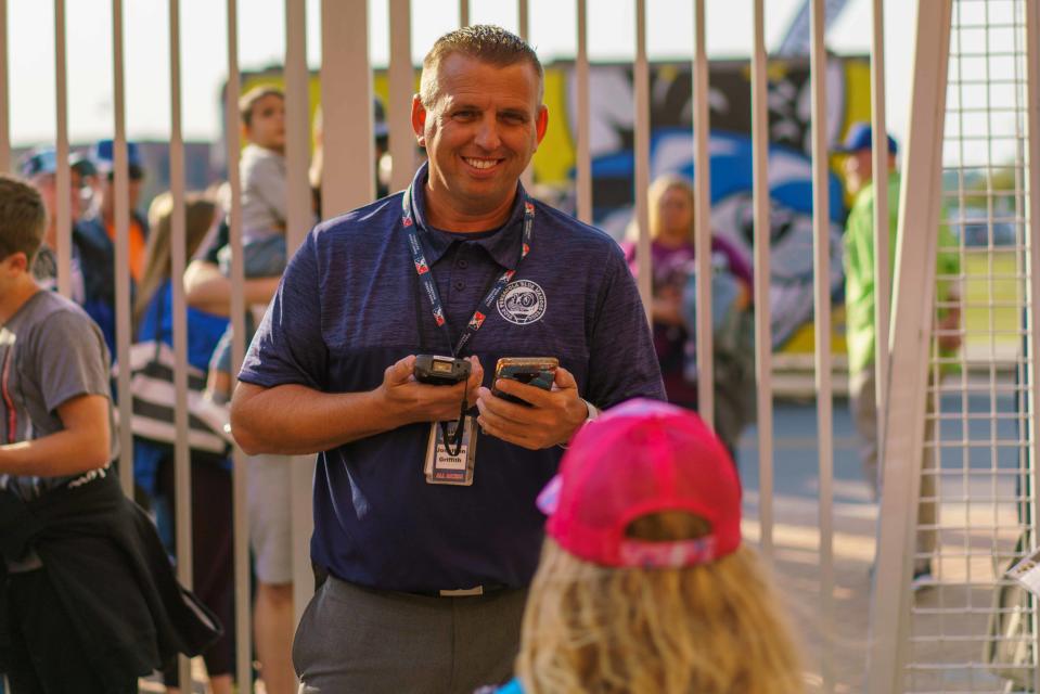 Blue Wahoos team president Jonathan Griffith greets fans and scans tickets during the 2022 season opener. The Blue Wahoos went to a digital ticket policy last year and will be a cashless venue for the 2023 season.