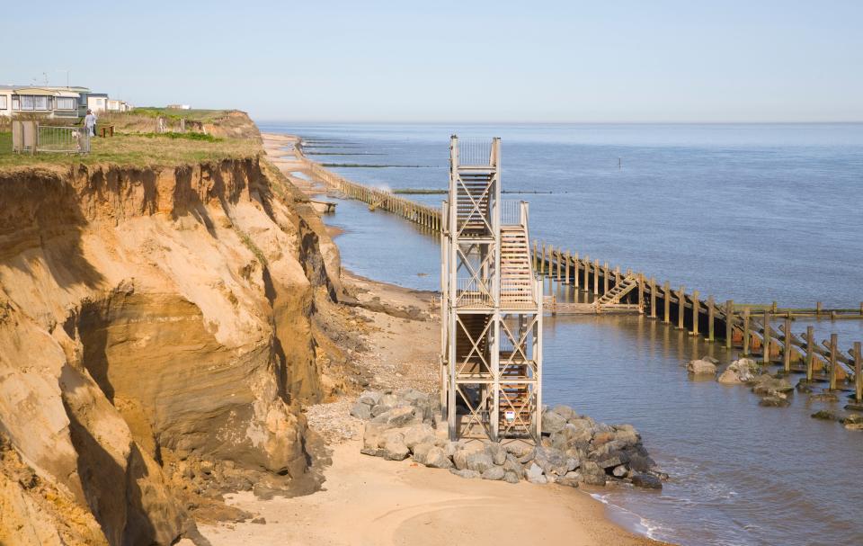Former beach access stairs now stand alone as coastal erosion continues, Happisburgh, Norfolk, England, pictured in 2006.