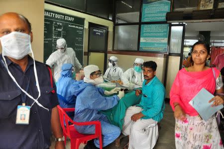FILE PHOTO: Medics wearing protective gear examine a patient at a hospital in Kozhikode in Kerala, India May 21, 2018. REUTERS/Stringer/File Photo