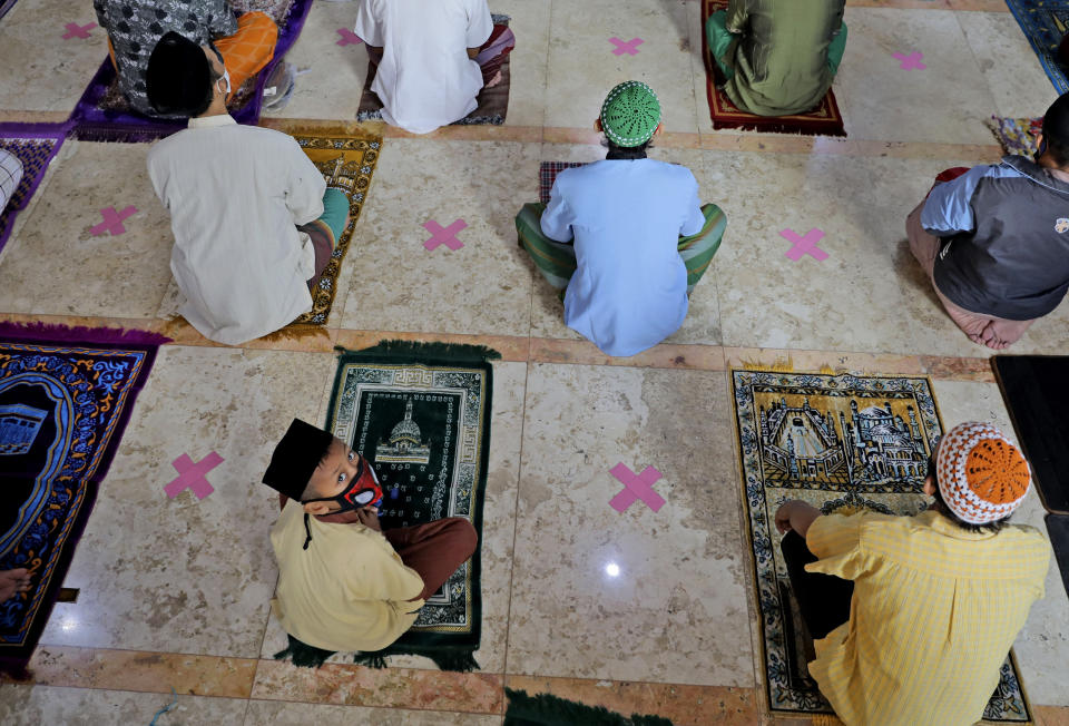 Indonesian Muslims pray spaced apart as they practice social distancing to curb the spread of the new coronavirus during an Eid al-Fitr prayer marking the end of the holy fasting month of Ramadan in Sidoarjo, East Java, Indonesia, Sunday, May 24, 2020. Millions of people in the world's largest Muslim nation are marking a muted and gloomy religious festival of Eid al-Fitr, the end of the fasting month of Ramadan _ a usually joyous three-day celebration that has been significantly toned down as coronavirus cases soar. (AP Photo/Trisnadi)