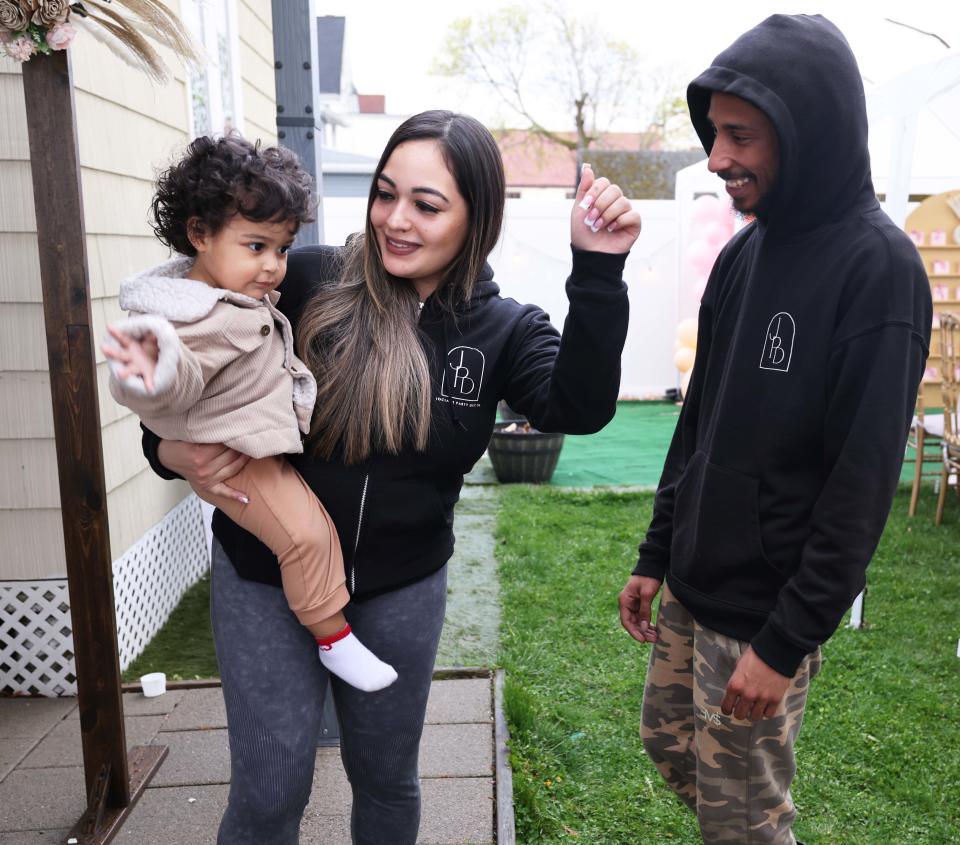 Cynthia Viruet, owner of Jociah Party Decor, with Rejay Fernandes and their son Jociah at a house party at North Main Street in Brockton on Saturday, April 20, 2024.