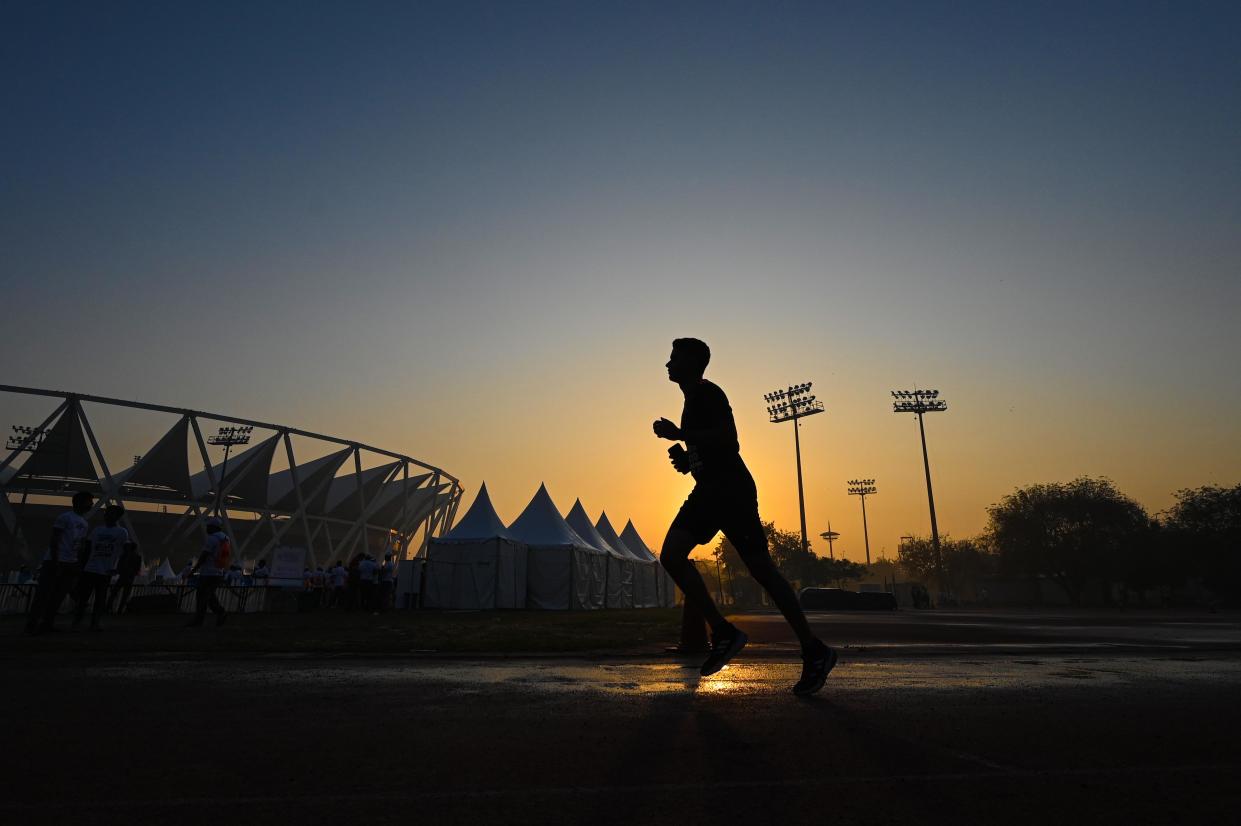 A runner outside Jawaharlal Nehru Stadium in New Delhi. (Sanchit Khanna/Hindustan Times via Getty Images)