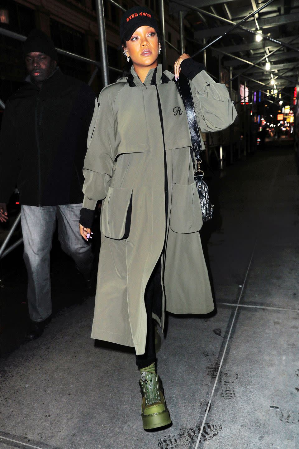 <p>In an all black outfit under a custom Ulyana Sergeenko olive trench coat with a black cap and green Fenty x Puma boots while out in New York City.</p>