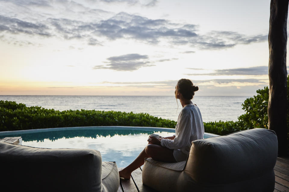 person sitting by the pool by themself