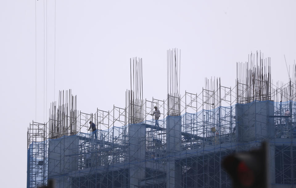 Workers walk on scaffoldings at a construction site in Hanoi, Vietnam on Wednesday, March 29, 2023. Vietnam's economy slowed sharply in the first quarter of this year, with growth coming in at a much weaker than expected 3.3%, as its exporters were hit by rising costs and weaker demand, the General Statistics Office reported Wednesday. (AP Photo/Hau Dinh)