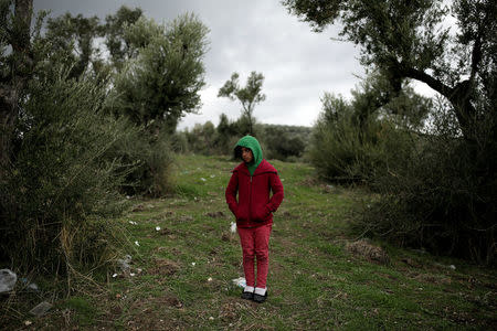 Arebi, a Syrian refugee girl, stands at a makeshift camp for refugees and migrants next to the Moria camp on the island of Lesbos, Greece, November 30, 2017. REUTERS/Alkis Konstantinidis