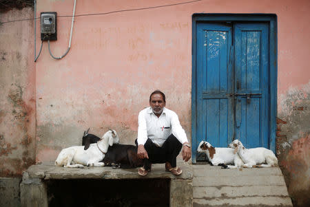 FILE PHOTO: Jabbar Ali, a carpenter, sits outside a house in village Nayabans in the northern state of Uttar Pradesh, India May 15, 2019. REUTERS/Adnan Abidi