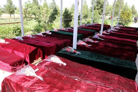 Coffins containing the bodies of Afghan national Army (ANA) soldiers killed in April 21's attack on an army headquarters are lined up in Mazar-i-Sharif, northern Afghanistan April 22, 2017. Presidential Palace /Handout via REUTERS